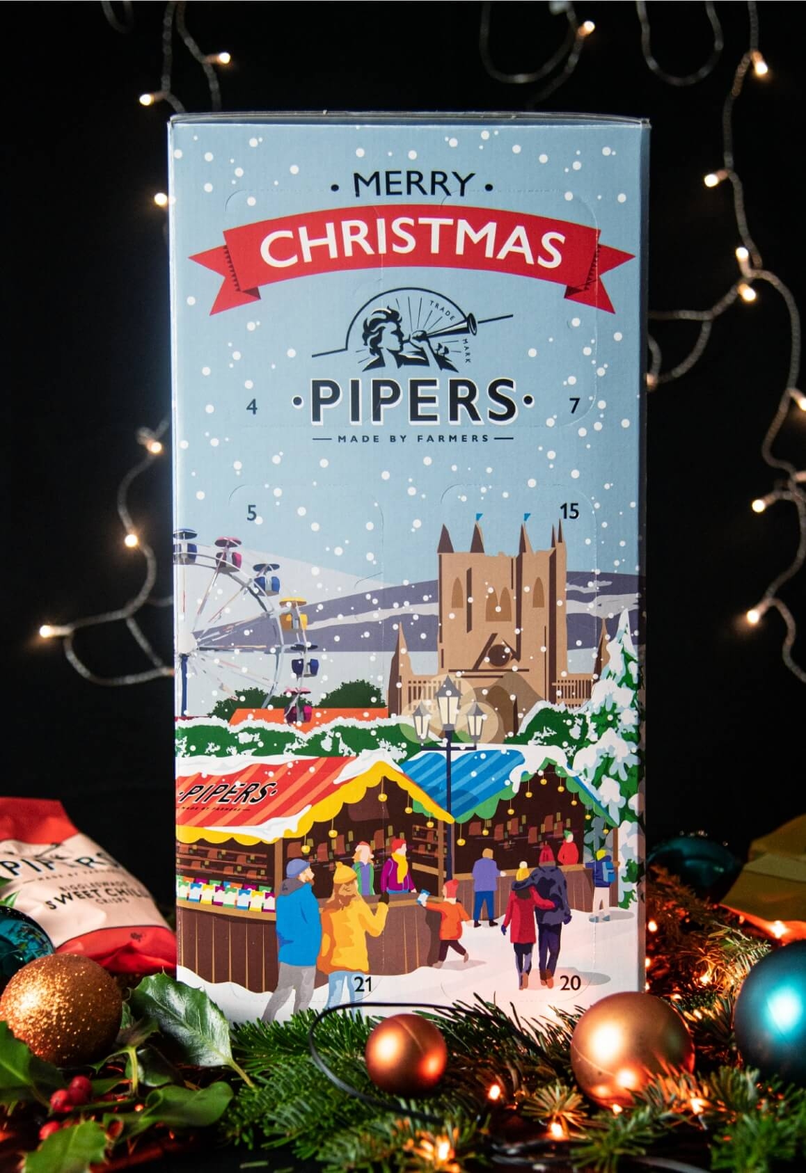 Pipers Crisps Advent Calendar surrounded by Christmas lights and baubles