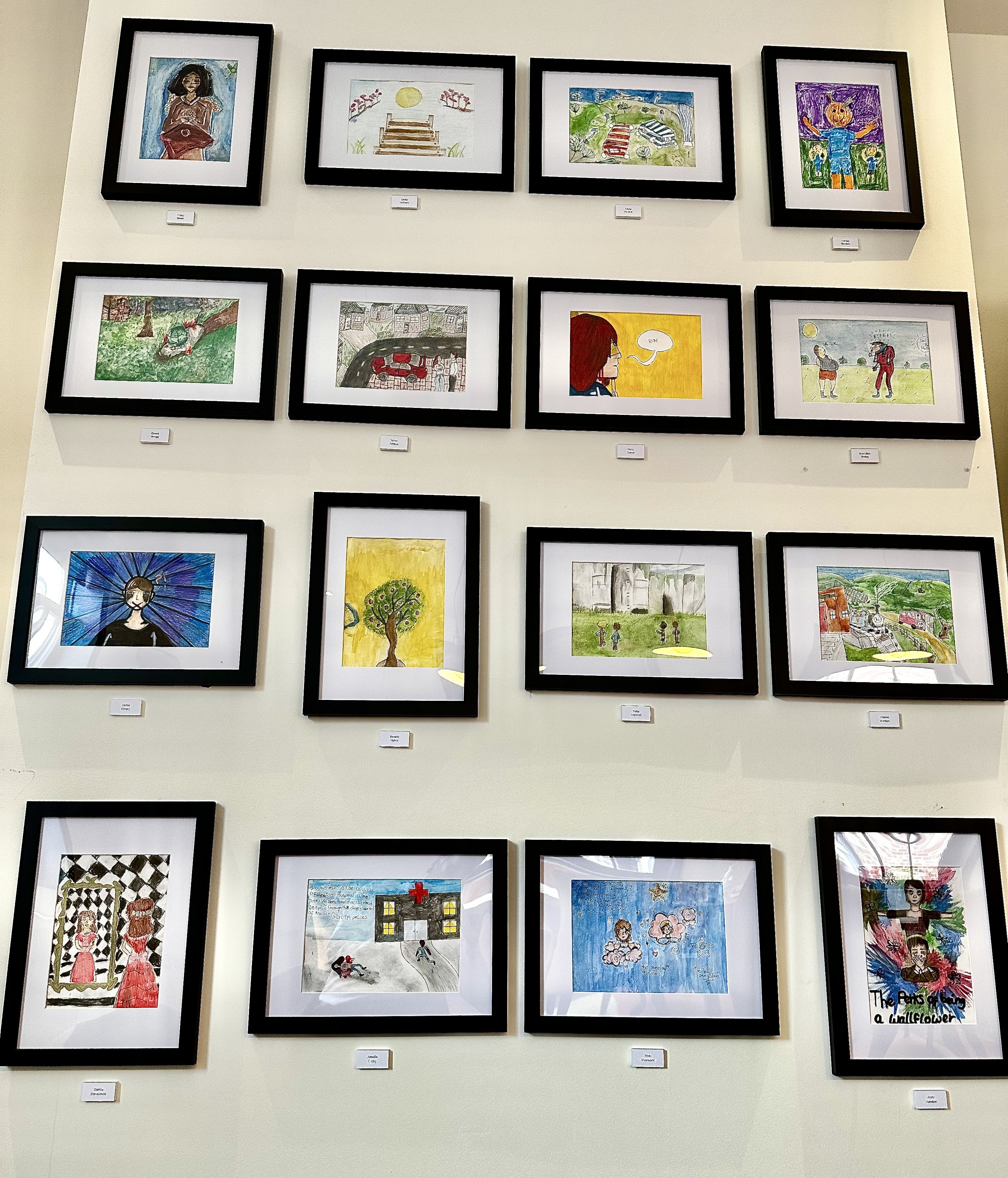 Artwork displayed on Optima Design's meeting room wall from school students